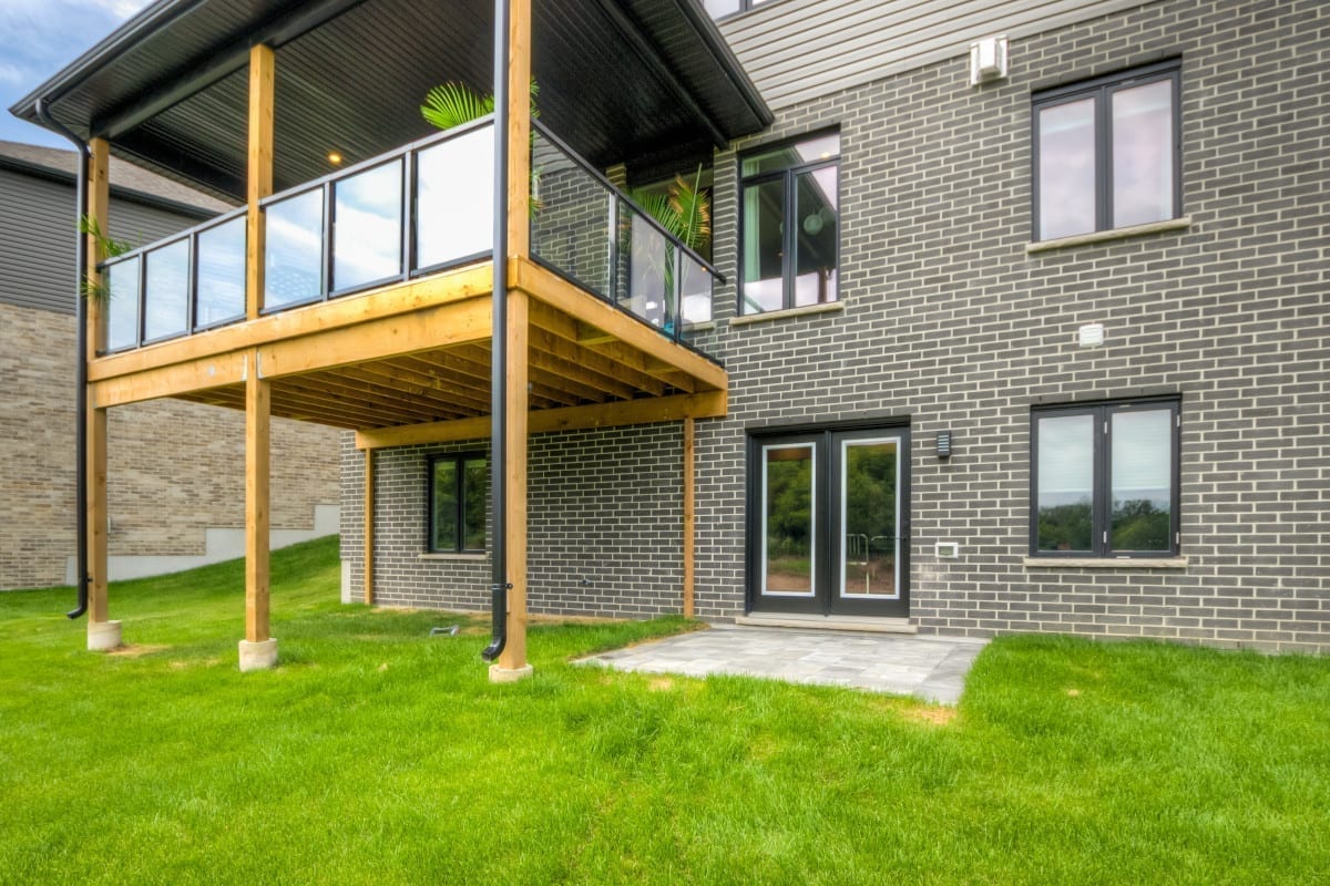 Exterior view showing the walk out and patio on a Meadowlily model home.