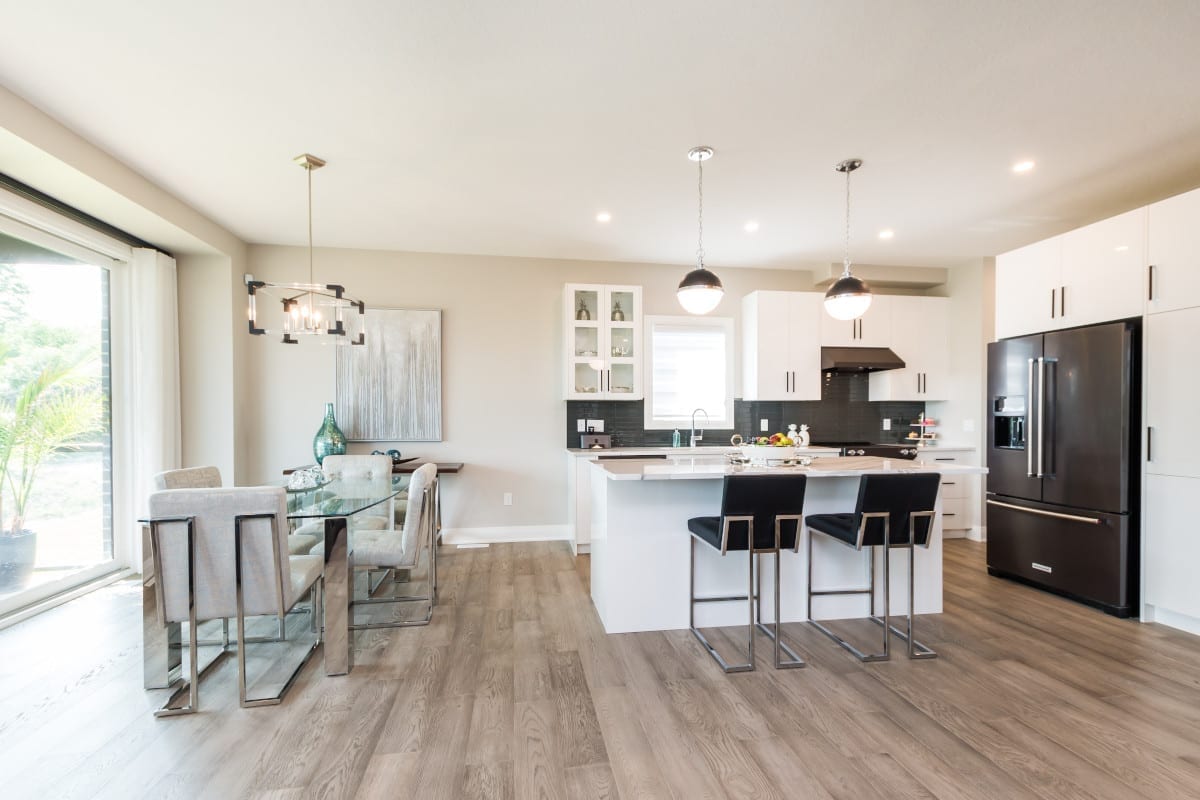 Spacious kitchen with a cozy dining area situated by the patio.