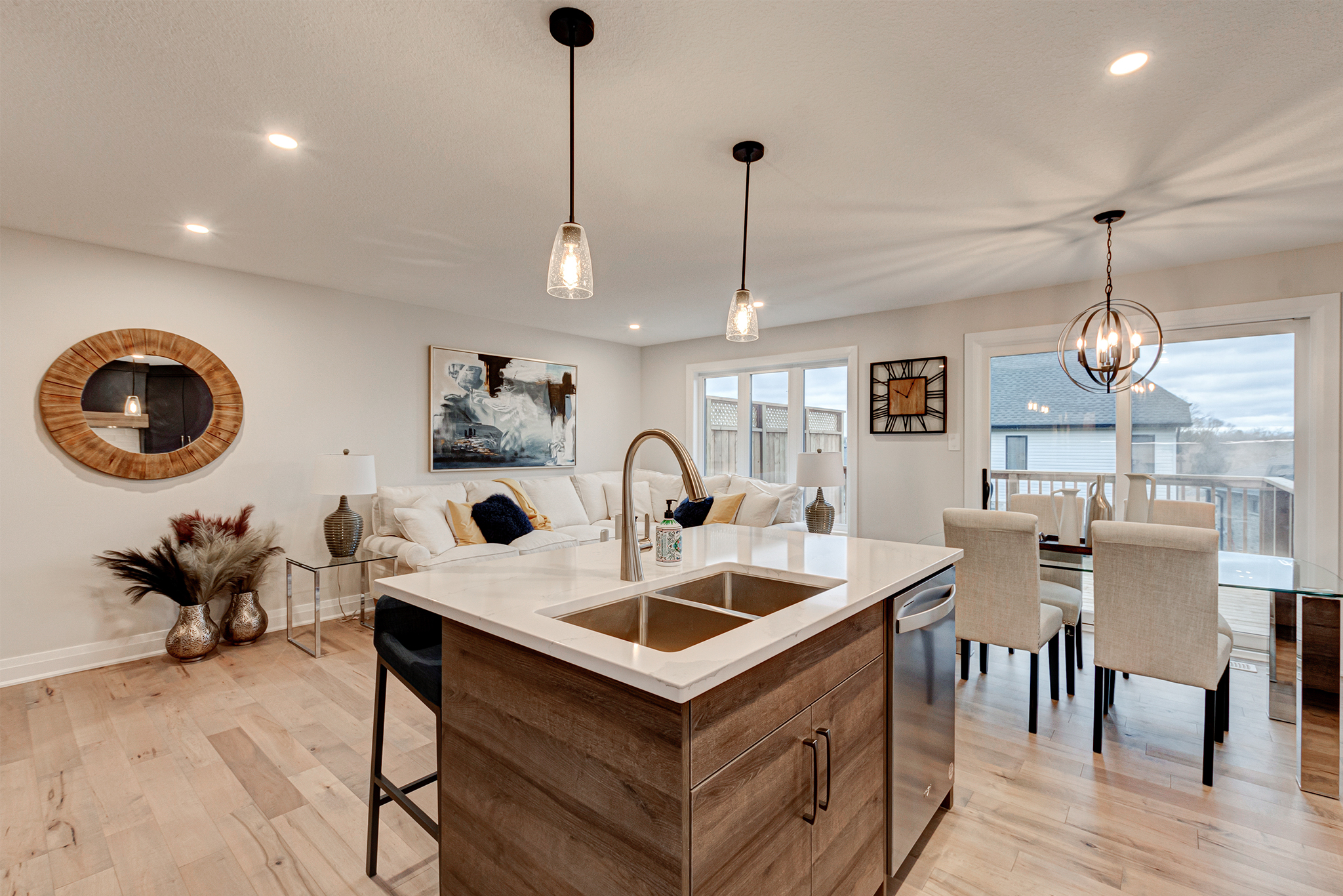 Kitchen island finished in wood tones in a model home at Upper West by Rembrandt Homes.