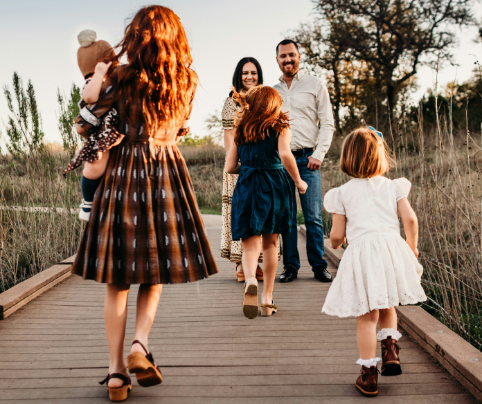 Family enjoying outdoor walk on trail.