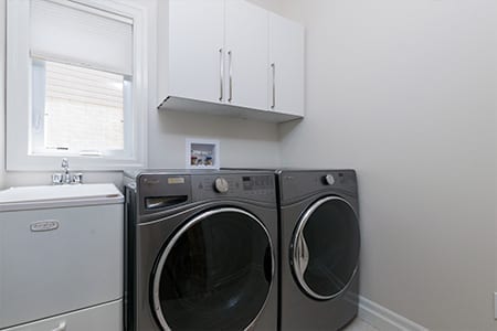 Rembrandt Estates - Laundry Room with washer,dryer, and sink - new homes ready to move in