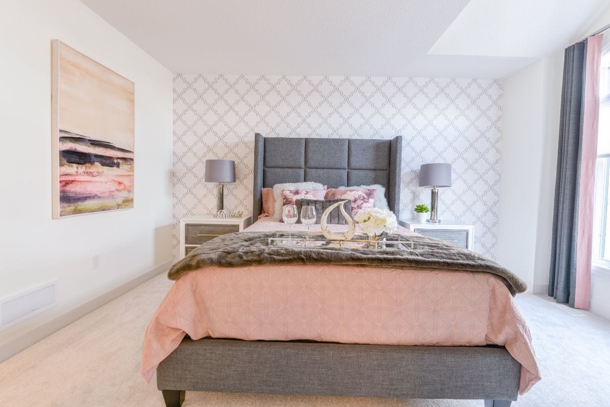 grey bed with large headboard in bedroom