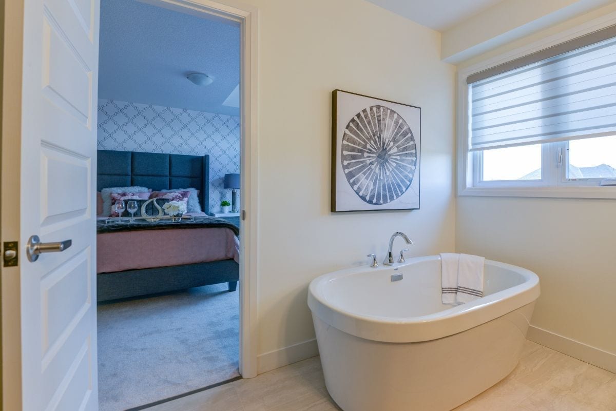 bathroom with view of the bedroom, bather has soaker tub
