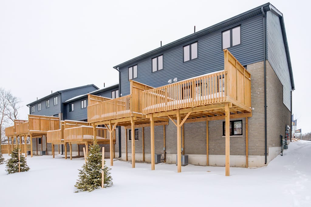 Backyard of House with Wooden Patio Balcony in Winter